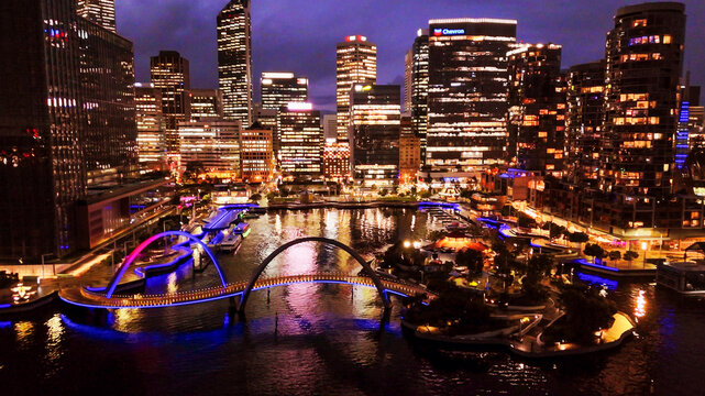 Elizabeth Quay waterfront and modern bridge in Perth city captured from above during night time