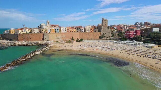 Termoli Molise Italy 4K drone video. Flyover turquoise sea pastel old town with castle wall and beach. Off the beaten path travel b roll stock footage