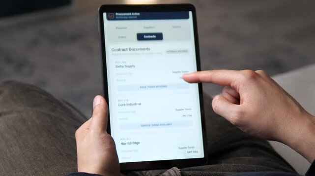 Business user reviews supplier contracts on a tablet, highlighting digital procurement, vendor management, purchasing transparency and modern supply chain operations.