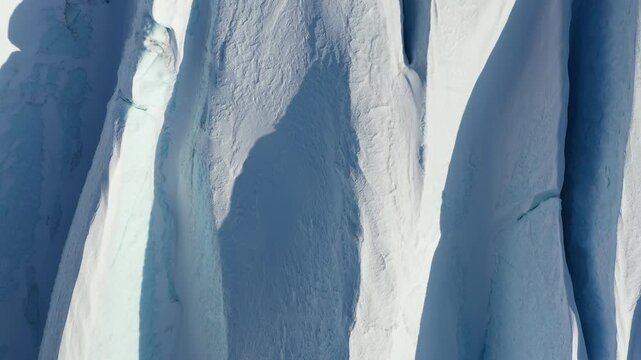 Abstract Top-Down Drone View of Blue Glacier Crevasse and Snow Texture