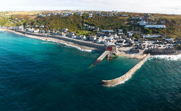Aerial landscape from the sea of the Cornish village of Sennen Cove in Cornwall, UK at sunset