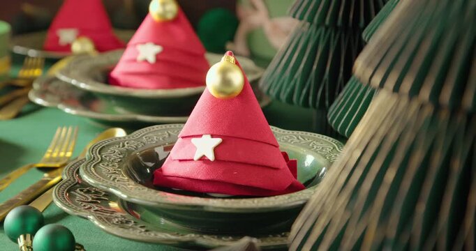 Contemporary green table arranged with baubles and ornaments.