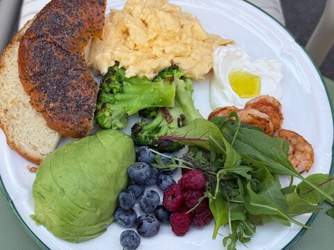 Healthy Breakfast Plate with Scrambled Eggs Avocado Broccoli Berries and Shrimp