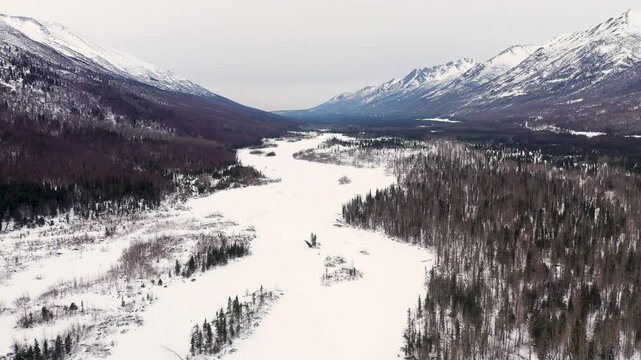 Aerial View of Snowy River Valley and Forested Mountains