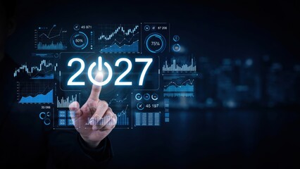 Obraz premium Finger pointing to futuristic 2027 digital interface with analytics and charts overlay