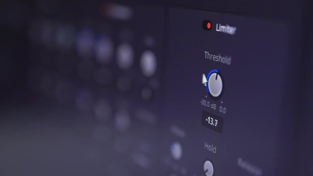 Close-up of rotating audio plugin knob with glowing LED indicators in dark mixing studio