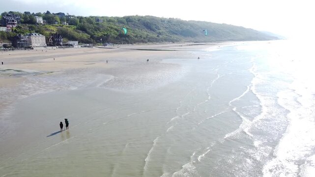 Aerial view of kitesurfers launching from a beach in Normandy, France