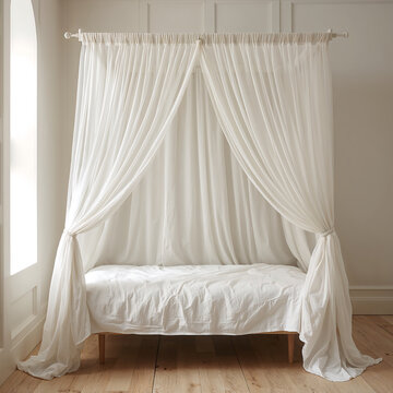 A four poster bed frame featuring flowing white sheer curtains draped elegantly over a wooden structure in a bright minimalist bedroom setting