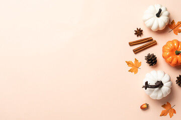 Obraz premium Autumn flat lay background. Pumpkins, spices and fallen leaves on color background.