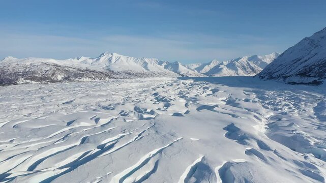 Panoramic View of Winter Glacial Basin and Snow-Capped Alpine Range