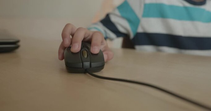 Close-up children's hand use computer mouse. 4K 10-bit