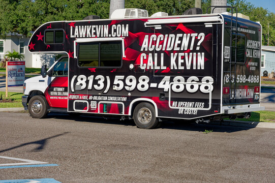 Bold mobile attorney advertising van parked in a suburban neighborhood, Editorial Use Only, September 26,  2026 ,St. Petersburg, FL ,USA  with prominent 'Accident? Call Kevin' text, large phone number
