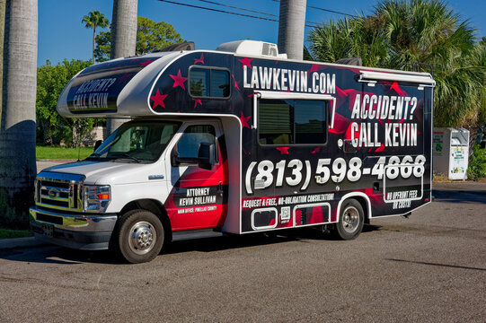 Bold mobile attorney advertising van parked in a suburban neighborhood, Editorial Use Only, September 26,  2026 ,St. Petersburg, FL ,USA  with prominent 'Accident? Call Kevin' text, large phone number
