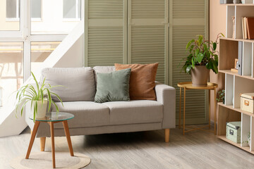 Interior design and home comfort, cozy living room with modern sofa and house plants for lifestyle and real estate staging in a bright apartment © Pixel-Shot