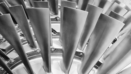 Close-up of metal turbine blades, tech industrial technology background © Aleksandr Matveev