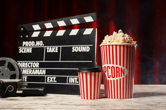 Cinema entertainment and movie industry, popcorn bucket with film clapperboard and vintage camera on table for film production and theater snacks