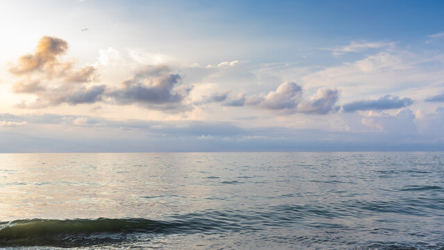 panoramic view of clouds and sea water at sunset