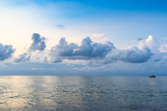 low clouds in dark blue sky over sea water at dusk