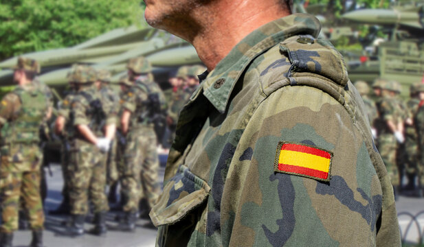 Spanish Army soldier with military troops and missiles in the background.