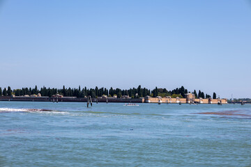 Venice Lagoon Waterfront Complex Beneath a Clear Blue Sky © Julia