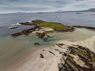 Aerial view of serene coastal inlet, calm waters, rocky shorelines, and distant hills. Overcast sky casts soft light over tranquil scene. Ideal for travel, nature, or environmental themes © mark_gusev