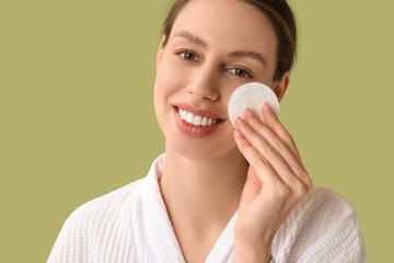 Skincare routine and facial cleansing, young woman removing makeup with cotton pad in bathrobe for daily beauty wellness and healthy skin care © Pixel-Shot