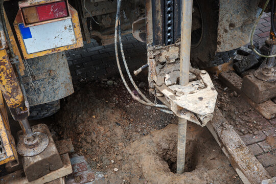 Borehole drilling into soil and ground during geotechnical construction investigation, testing and engineering work examining subsurface conditions