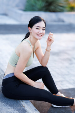 Portrait of beautiful asian woman in robe sportswear working out outside. training on public equipment in outdoor at park. concept Exercise Healthy lifestyle.