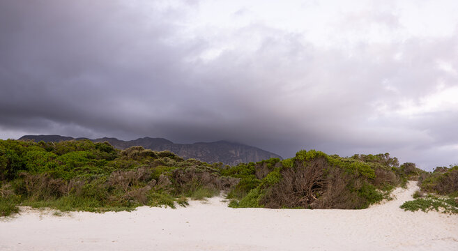 beautiful sunset and dusk light falling upon Grotto lagoon and rock formations, Hermanus, South Africa