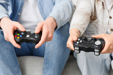 Gaming and leisure, couple playing video games together at home with game controllers for entertainment and digital recreation in a casual lifestyle © Pixel-Shot