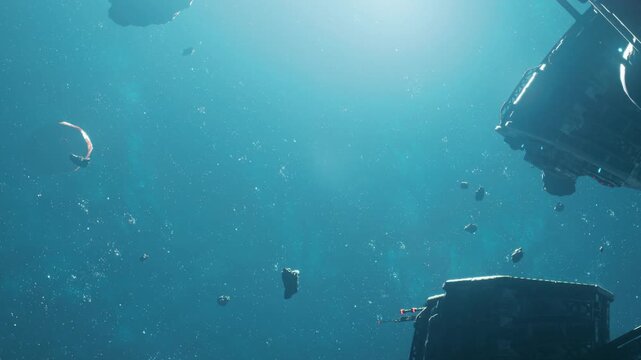 In a deep underwater setting, objects float freely in the blue water as sunlight filters through. The scene captures the stillness of the surrounding space and the beauty of aquatic life.