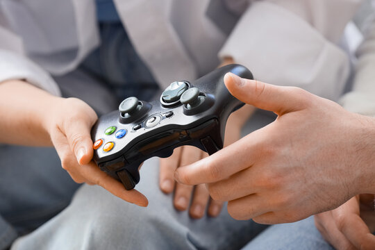 Gaming and social connection, couple playing video games together at home with a controller for entertainment and leisure time in a casual setting