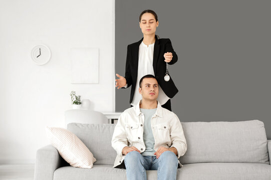 Hypnotherapy and mental health treatment, professional therapist using a pocket watch to hypnotize a patient for stress relief and behavioral change