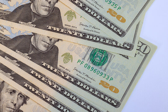 Twenty dollar cash banknotes issued by National Bank stacked together, financial wealth savings.