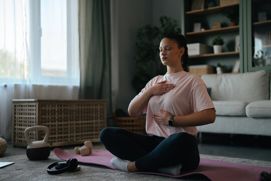 Young woman practicing mindful breathing and meditation at home