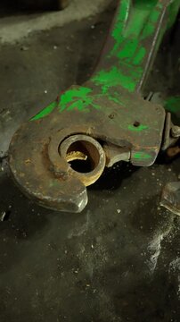 A rusty part undergoing restoration in a factory workshop. Metalworking concept.