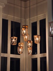 Modern wooden pendant chandelier light fixture with warm ambient glow © TariqulIslam