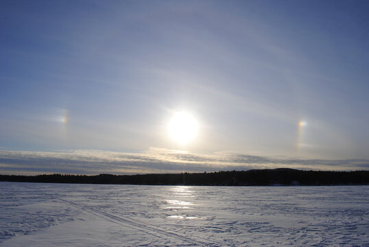 Rainbow, sun dog over Sebago Lake, Maine in winter