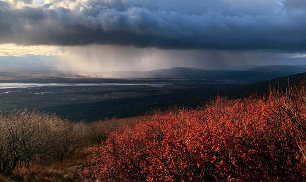Dramatic storm clouds rain over rolling hills