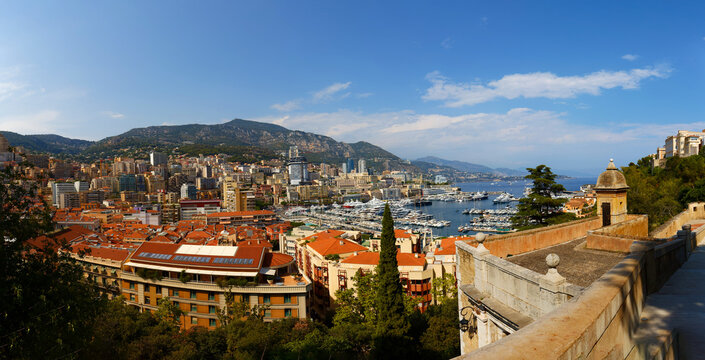 Panoramic view of Monaco skyline, marina with luxury yachts and mountains, Cote d'Azur, French Riviera