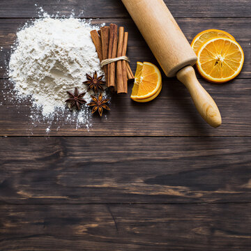Holiday baking ingredients with cinnamon and orange flat lay
