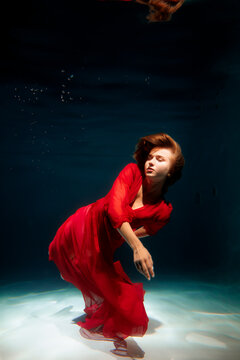 Reflective scene with flowing fabric and subdued lighting