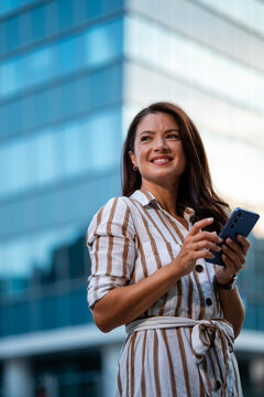 Professional woman using smartphone in urban setting