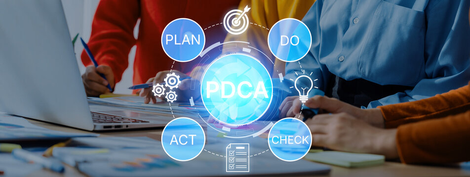 Team Collaboration on Business Strategy Using PDCA Methodology with Charts and Laptops in Modern Office Environment. Bitwise.