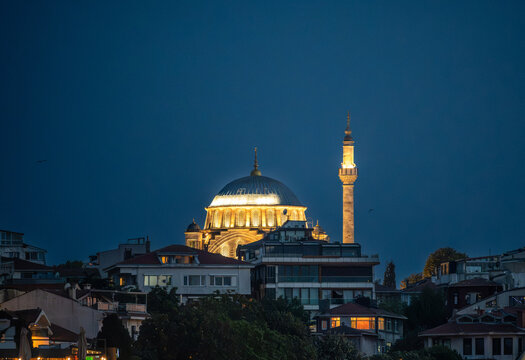Istanbul,turkey,august 4, 2025. Nuruosmaniye mosque dome and minaret glowing at twilight above istanbul rooftops, illuminated ottoman landmark overlooking the cityscape