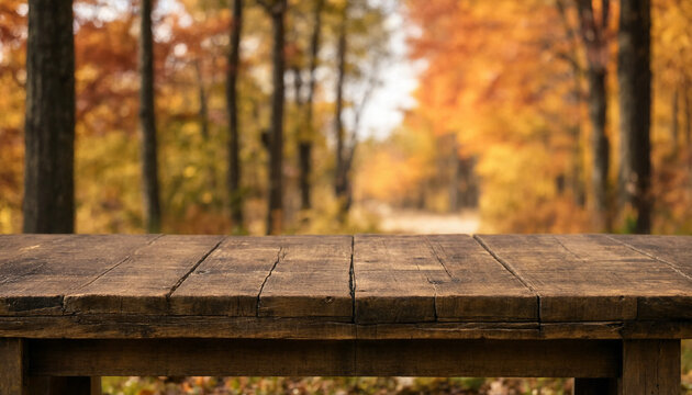Rustic wooden picnic table with autumn forest bokeh background for seasonal marketing