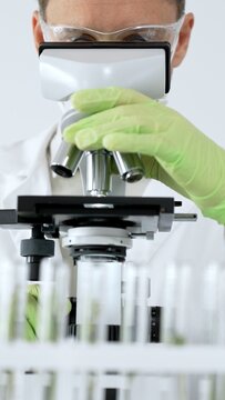 Scientist working with microscope, analyzing biological samples in a research laboratory, driving a medical discovery, conducting biotech analysis for scientific innovation