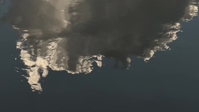 Cloud reflection on rippling water surface in Chiang Mai