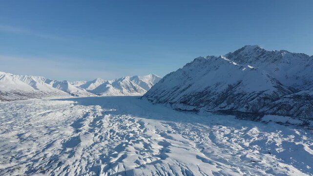 Panoramic Drone Flyover Above Vast Glacier Field Flanked by Snowy Peaks