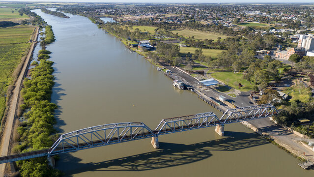 Aerial drone view of the historic steel truss railway bridge spanning the Murray River at Murray Bridge, South Australia,&nbsp;with foreshore park, riverbanks, and surrounding regional township buildings